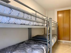 a couple of bunk beds in a room at Experience Valencia Bnb - Rincon del Mar - Apartamento Maravilloso a Canet Playa 100 mt in Canet de Berenguer