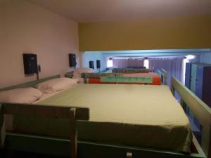 a bedroom with three beds in a room at Hostel del Puerto in Punta del Este