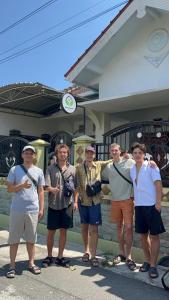 a group of men standing in front of a building at Twentynine Homestay in Banyuwangi