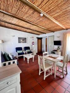 a living room with a table and chairs and a couch at Baywatch Paternoster - The Cottage in Paternoster