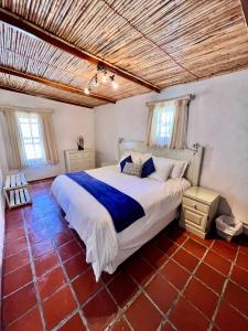 a bedroom with a large bed in a room at Baywatch Paternoster - The Cottage in Paternoster