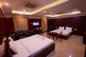 Hotel PVK Grand Dindigul客房内的一张或多张床位