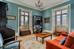 a living room with a couch and a table at Casa da Avó in Caminha