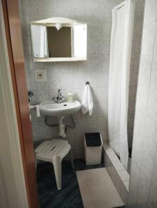 a small bathroom with a sink and a shower at Pokoje Gościnne u Kasi in Międzywodzie