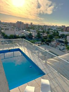 a swimming pool on the roof of a building at La Gioconda Apart Hotel in Villa María