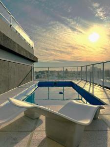 a bath tub sitting on the roof of a building at La Gioconda Apart Hotel in Villa María