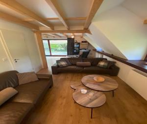 a living room with a couch and two tables at Kom tot rust midden de natuur! Top Locatie! Top Deal!! in Bovenwezet