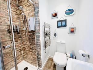 a bathroom with a shower and a toilet at Lundy SeaView Great Sea-views in Westward Ho