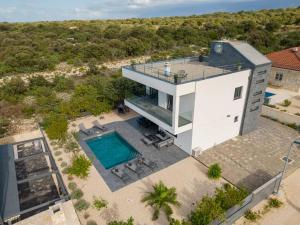 an aerial view of a house with a swimming pool at Vacation House Marton - Mandre, Pag in Kolan