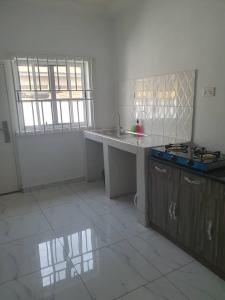 a kitchen with a sink and a counter top at Sigma Theta Homes - Old Tafo in Kumasi