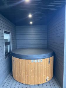 a sauna with a wooden barrel in a room at Belraugh Mountain View Hot Tub Lodges in Garvagh