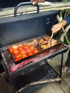a person is cooking food on a grill at Zoo si homestay in Sa Pa