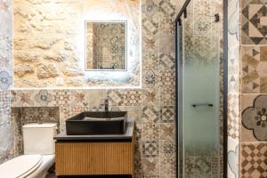 a bathroom with a sink and a glass shower at NEW Gorgeous Flat-Central Area in Paris