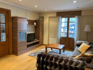 Una sala de estar con un sofá y una mesa de café. en Urumea Apartamento, en Goizueta