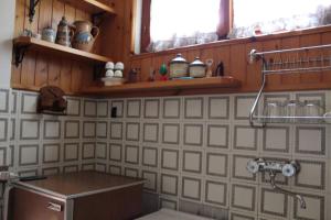 a kitchen with a sink and a counter top at La casa di Minù in Roccaraso +15 photos