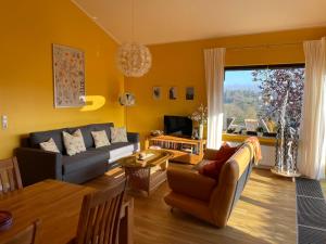 a living room with a couch and a table at Traumhaus am Maar 1 in Schalkenmehren