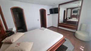 a bedroom with a bed and a large mirror at STOP TIME HOTE in Rio de Janeiro