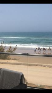 a view of a beach with horses walking on the sand at Holikeys - Agadir - 2 Ch - Aourir 005 in Agadir