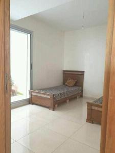 a room with two beds and a large window at Holikeys - Agadir - 2 Ch - Aourir 005 in Agadir