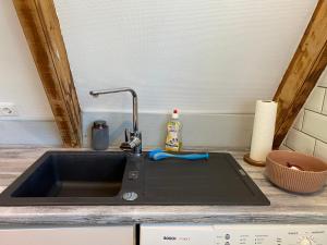 a kitchen sink with a faucet on a counter at Ferienhaus Seemöwe in Damp +102 photos