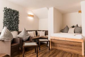a room with a bed and a couch and chairs at Ferienwohnung am Kurpark in Bad Lauterberg