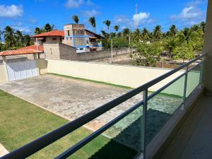 a balcony with a view of a house at Meu Chale Flecheiras in Flecheiras