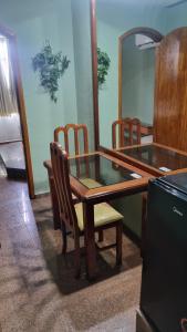 a table and chairs in a room with a mirror at STOP TIME HOTE in Rio de Janeiro