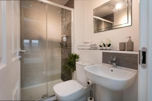 a bathroom with a toilet and a sink and a shower at Jasmine House in Nottingham +13 photos