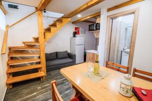 a living room with a table and a staircase at Apartments Rosana in Umag