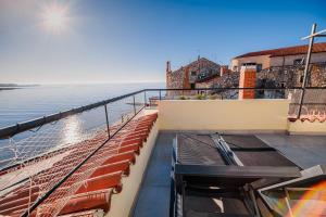 a balcony with a view of the water at Apartments Rosana in Umag