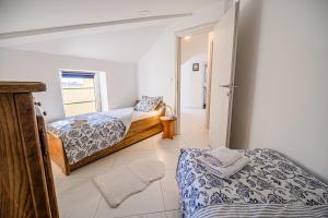 a bedroom with two beds and a hallway at Apartments Rosana in Umag