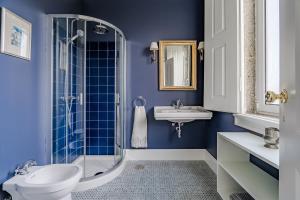 a blue bathroom with a toilet and a sink at Casa da Avó in Caminha +45 photos