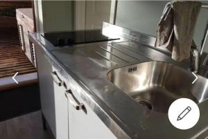 a stainless steel sink in a small kitchen at Austefjorden Fjordsuite med Panoramautsikt in Forland