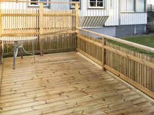 a wooden deck with a table and a fence at 2 person holiday home in Falkenberg in Falkenberg