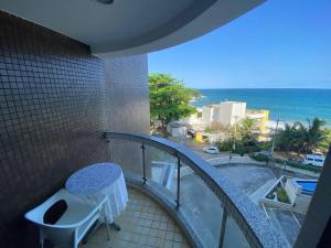 a balcony with a toilet and a view of the ocean at Vista incrível para o mar / Beautiful ocean view in Salvador