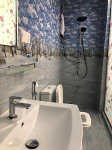 a bathroom with a sink and a toilet and a shower at The WISH RESIDENCE in Colombo