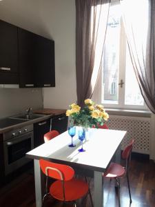 a kitchen with a white table with flowers on it at ITD unione in Milan