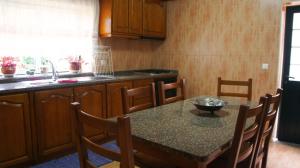 a kitchen with a table with a bowl on it at Casa da Igreja by Gerês Casas in Geres +18 photos