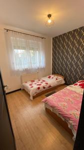 a bedroom with two beds and a window at Dom #BESKIDZKA in Rzeszów