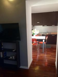 a living room with a table and chairs and a kitchen at ITD unione in Milan