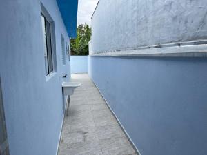 um corredor de um edifício com um lavatório e uma janela em Casa nova e móveis novos em Caraguatatuba