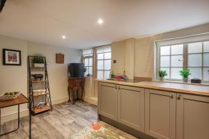 a kitchen with a sink and a counter top at The George Hotel, Dorchester-on-Thames, Oxfordshire in Dorchester on Thames