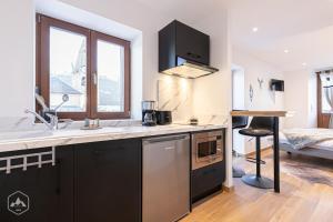 a kitchen with a sink and a counter top at ALPINA LODGE VANOISE ex hotel du soleil in Aussois +26 photos