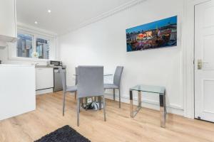 a kitchen with a table and two chairs and a table and a table at 2 Bed Piccadilly Apartment- 4 in London