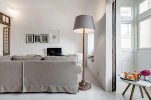 un soggiorno con divano e lampada da pavimento di Authentic Seafront Experience a Sliema