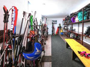 a room with a bunch of skis and ski equipment at Hotel Arlecchino - Dada Hotels in Madesimo
