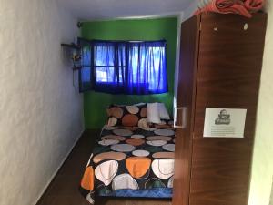 een kleine slaapkamer met een bed en een raam bij Casa en Atlántida, Barrio Español, Uruguay in Villa Argentina