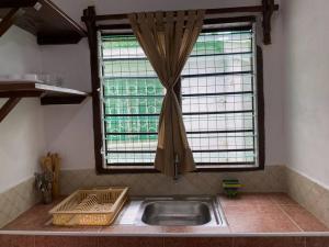 a kitchen with a sink and a window at Cynthia’s Homestays@0723632635 in Malindi