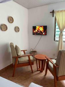 a living room with a fire on the wall at Cynthia’s Homestays@0723632635 in Malindi