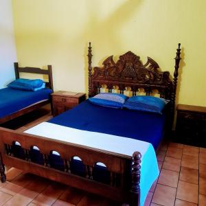 a bedroom with two beds with blue pillows at Hotel River Plaza in Rio Novo